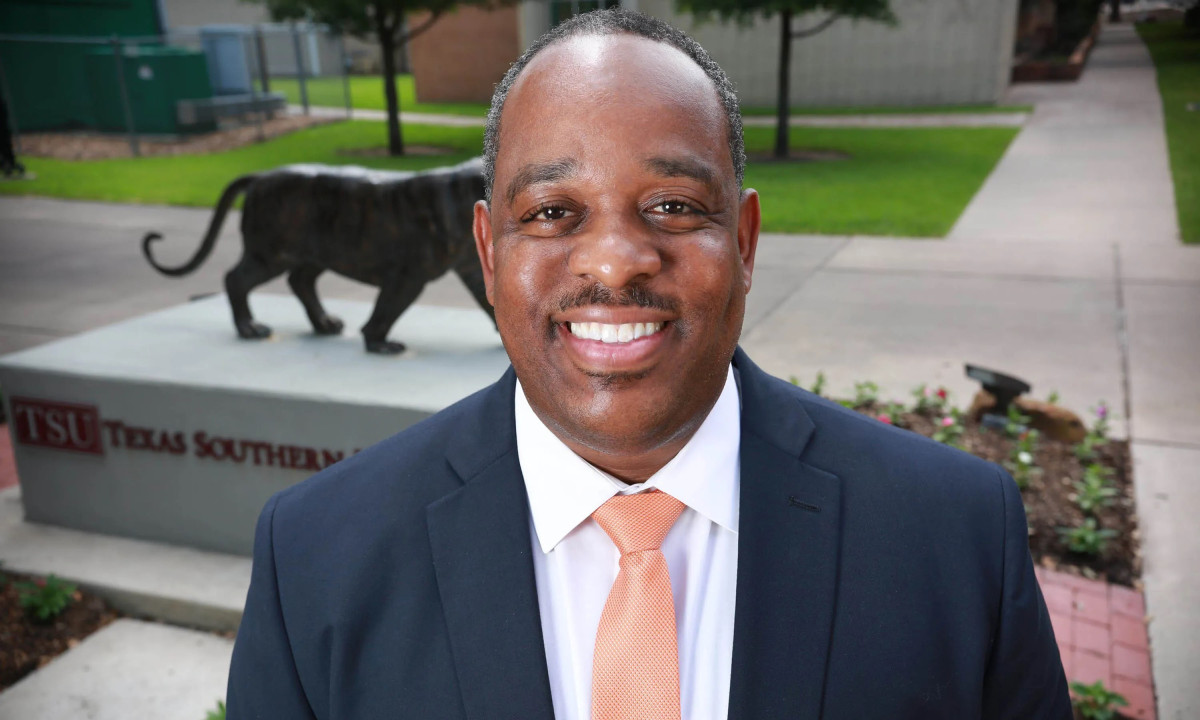 Headshot of Howard Henders standing in front of a statue of a tiger at Texas Southern University.